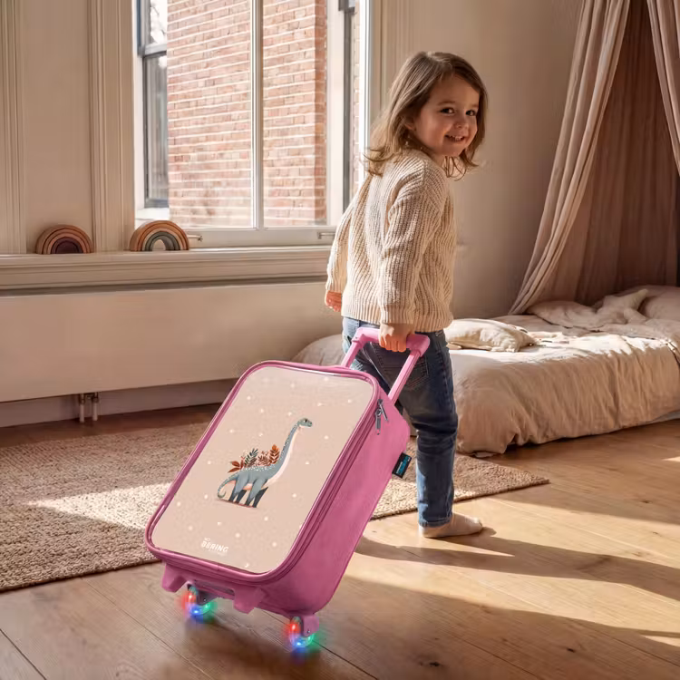 Blauwe dinosaurus op een beige stippenachtergrond Kinderkoffer - Roze klein -sfeer1